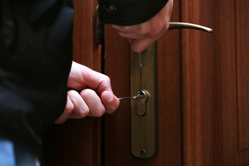 A thief trying to unlock the door