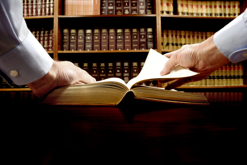 Photo of a man listing a book