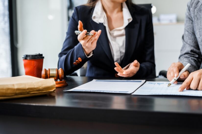 Two lawyers discussing particulars of a case over documentation