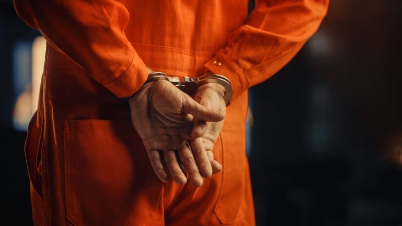 handcuffed suspect in person at federal criminal trial